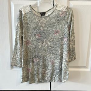 Pale pattern on grey background with lace on shoulders and top of back.